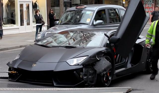 Wrecked Matte Black Lamborghini Aventador Towed