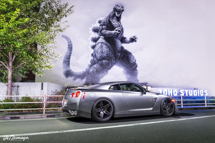 Grey Nissan GT-R and Godzilla