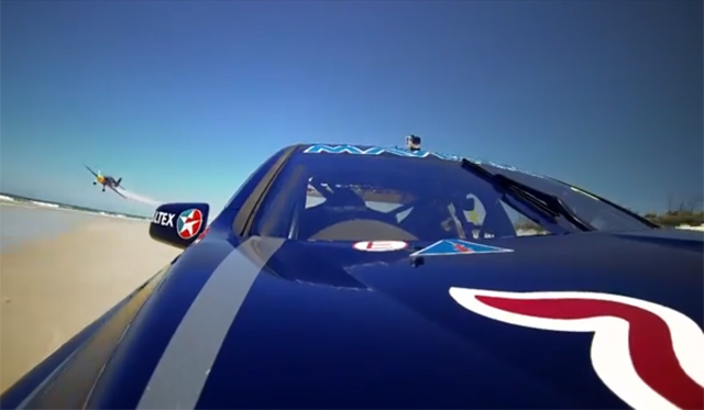 V8 Supercar on Sand Races Red Bull Stunt Plane